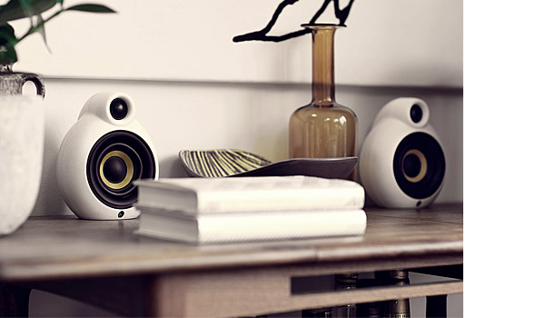 Micropod Bluetooth loudspeakers in white, on shelf.