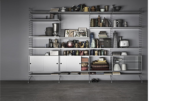 String shelving system. Shown here with a combination of grey floor panels with grey shelves, magazin board, normal cabinets and display cabinets.