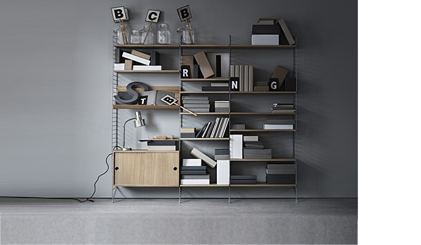 String shelving system. Shown here with grey floor panels and oak shelves, cabinet and magazin holder.