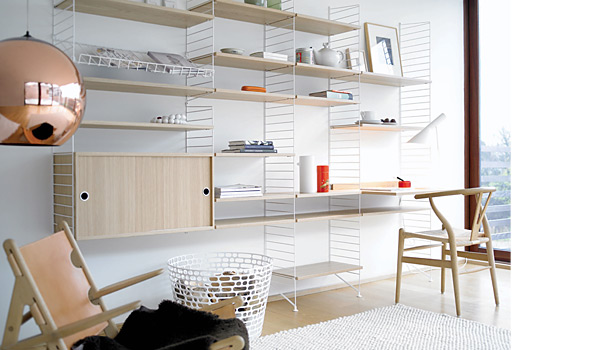 String shelving system. Shown here with a combination of white floor panels and oak shelves, cabinet and work surface.